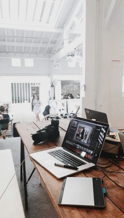 pexels photo 699459 699459 A bright, modern workspace featuring laptops, a camera, and a drawing tablet in an indoor office.